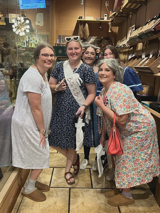 Young women dressed as elderly ladies smoking cigars at The Epitome in Biloxi